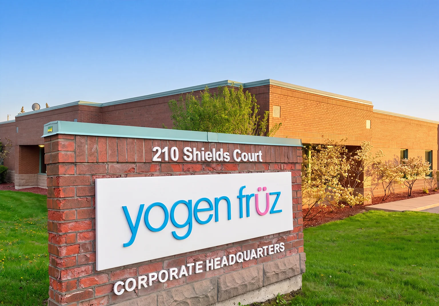 The Yogen Früz head office building, with a sign reading 210 Shields Court, Corporate Headquarters