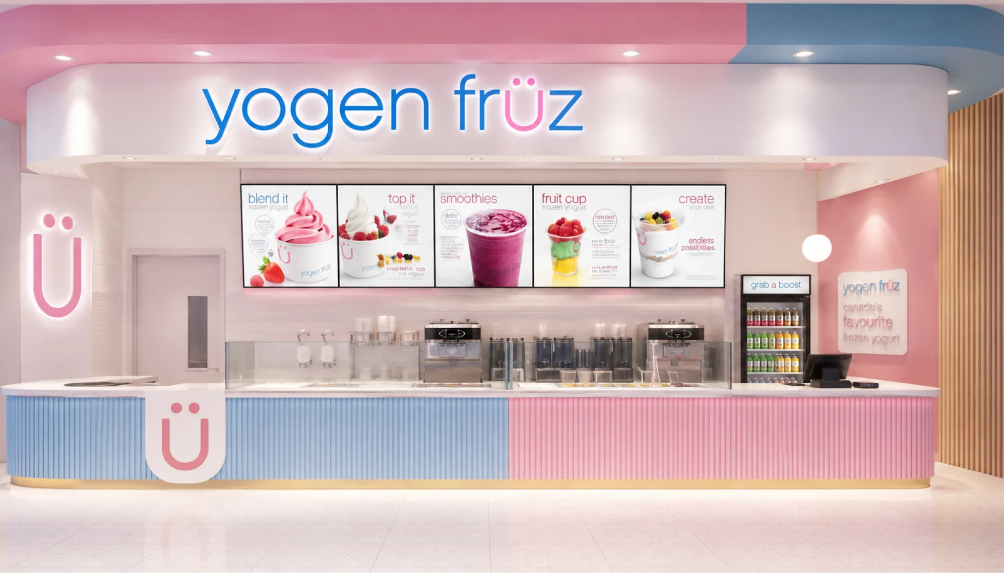 Yogen Früz storefront with illuminated menu boards and a pink and blue counter