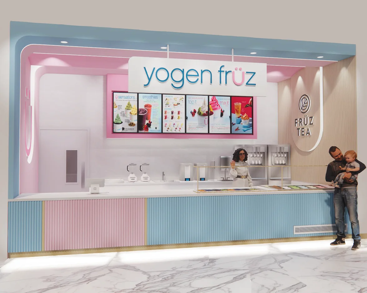Yogen Früz inline counter with an illuminated sign, menu screens and a customer holding a child