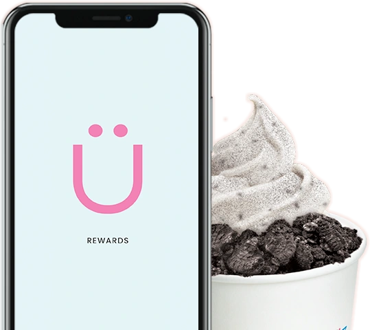 A phone showing the Yogen Früz Ü Rewards screen beside a cup of cookies and cream froyo